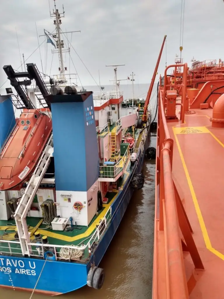 Bunker barge alongside a vessel at Zona Comun anchorage