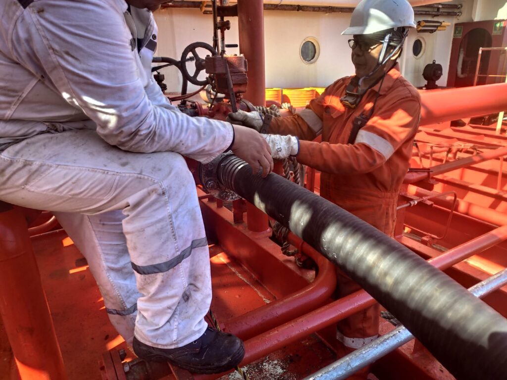 Bunker hose being connected at the manifold by the vessel crew
