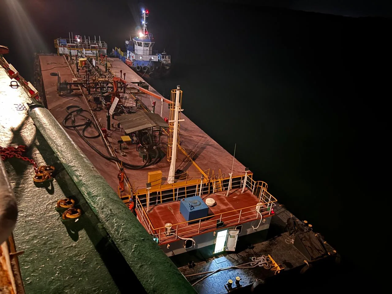 Bunker barge alongside the vessel at Paranaguá anchorage during the night delivery