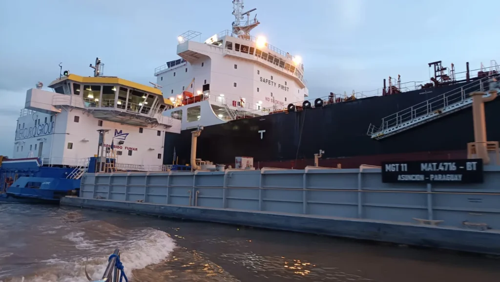 Pusher tug and tank barge registered in Asunción, Paraguay, alongside a tanker